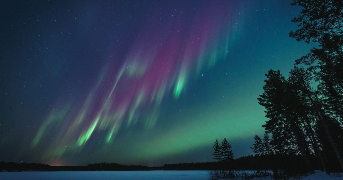 Northern lights over a lake in Oulu, Finland
